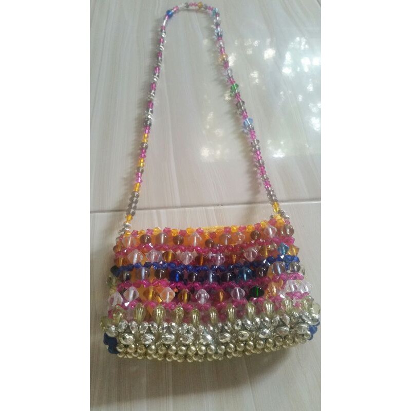 Beaded sling outlet bag