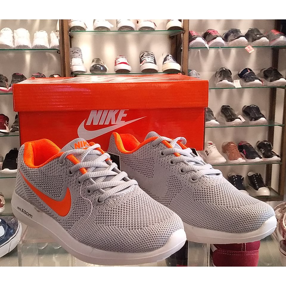 Nike grey and orange 2024 sneakers