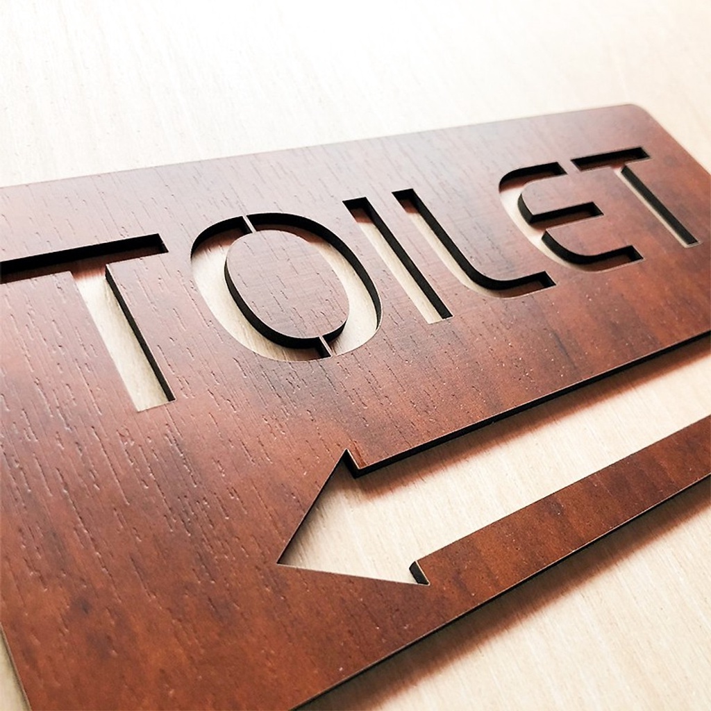 Wall-mounted toilet board with wooden painting indicating toilet room ...