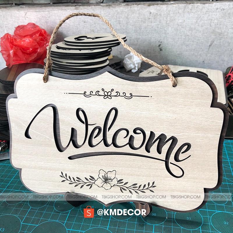 Wooden welcome sign hanging on glass door with pre-tied sedge string ...