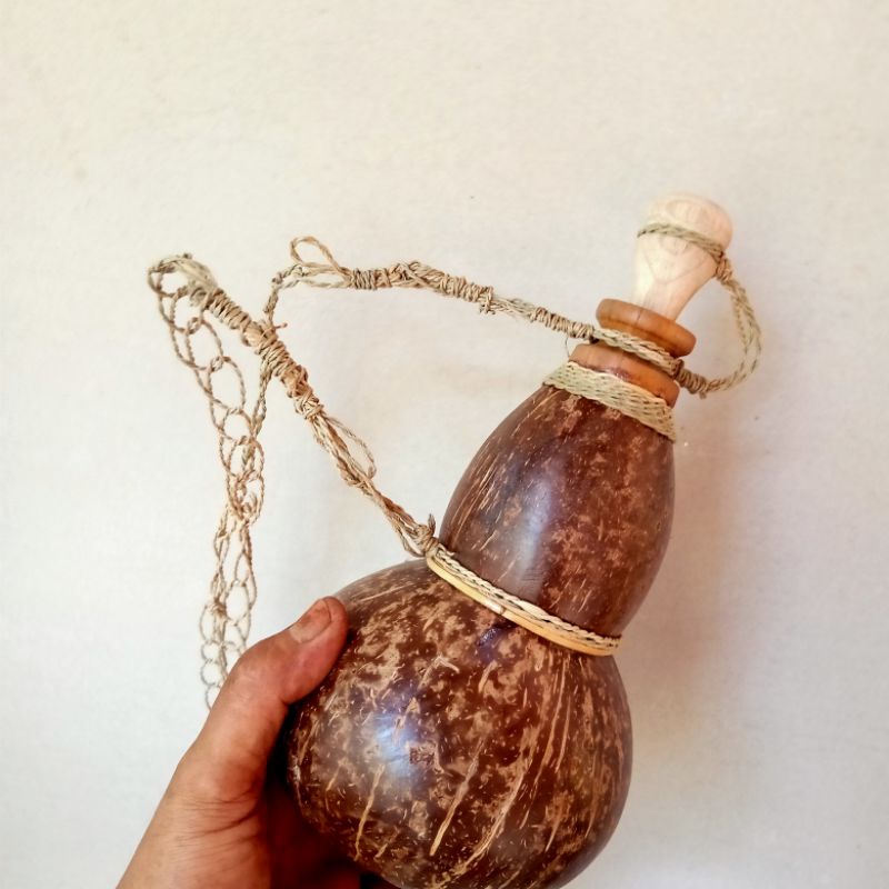 Deflated drinking water from old ethnic coconut shells, old school and ...