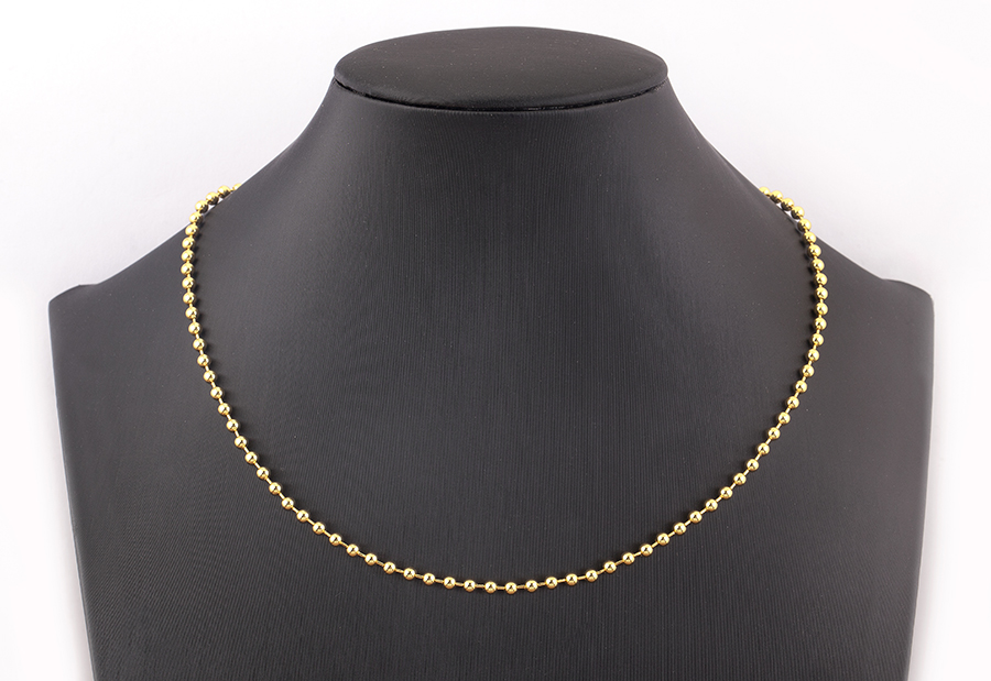 Fashion Bijouterie - a Large Gold Chain Bracelet on a White Stand Stock