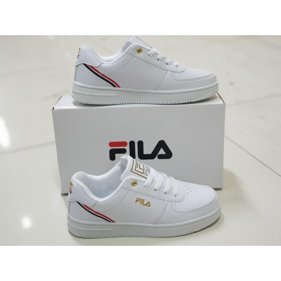 Fila white best sale and gold trainers