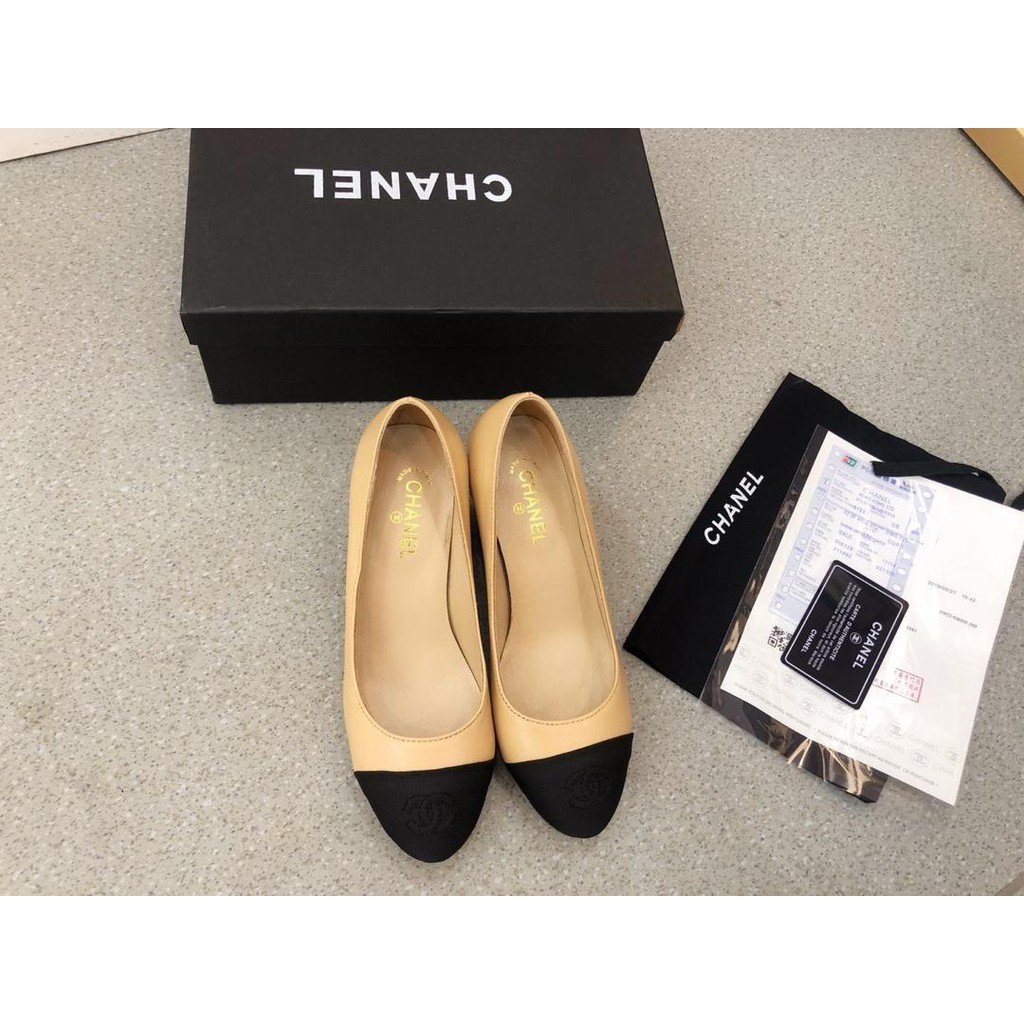 Chanel cream and black hot sale shoes