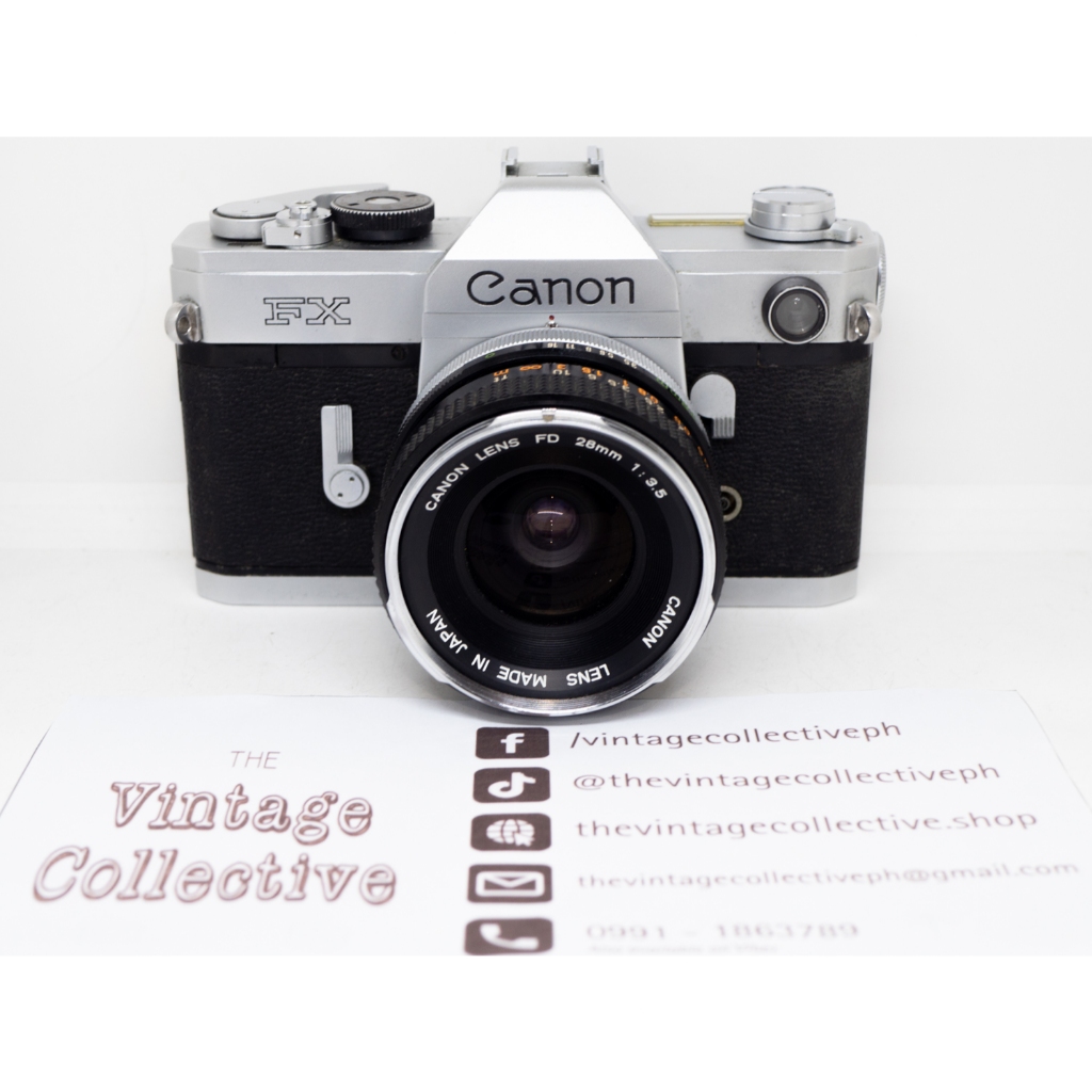 Canon FX 35mm film SLR camera with 28mm f/3.5 Canon FD wide angle lens ...