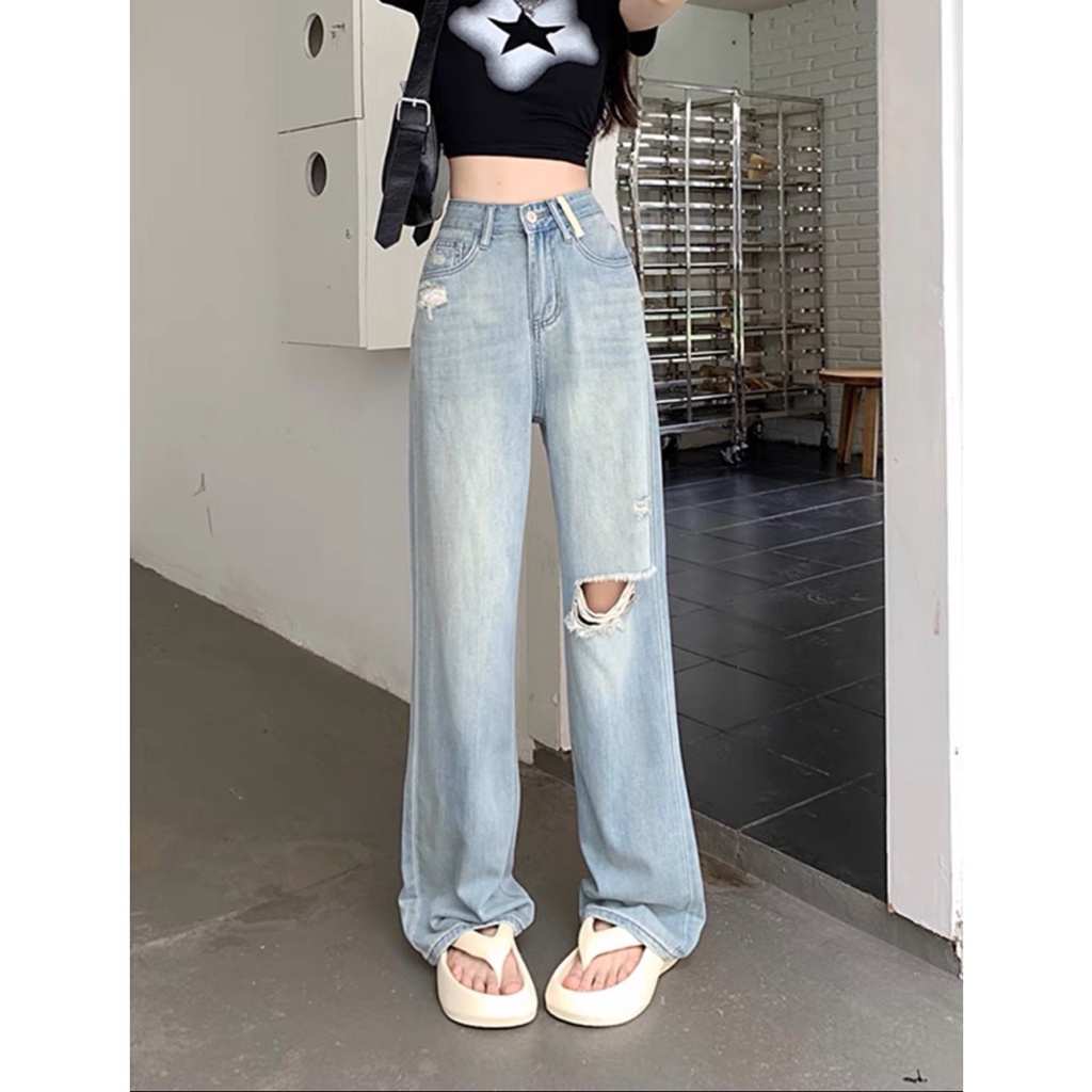Women's blue wide-leg jeans with slight ripped knees with red letters ...