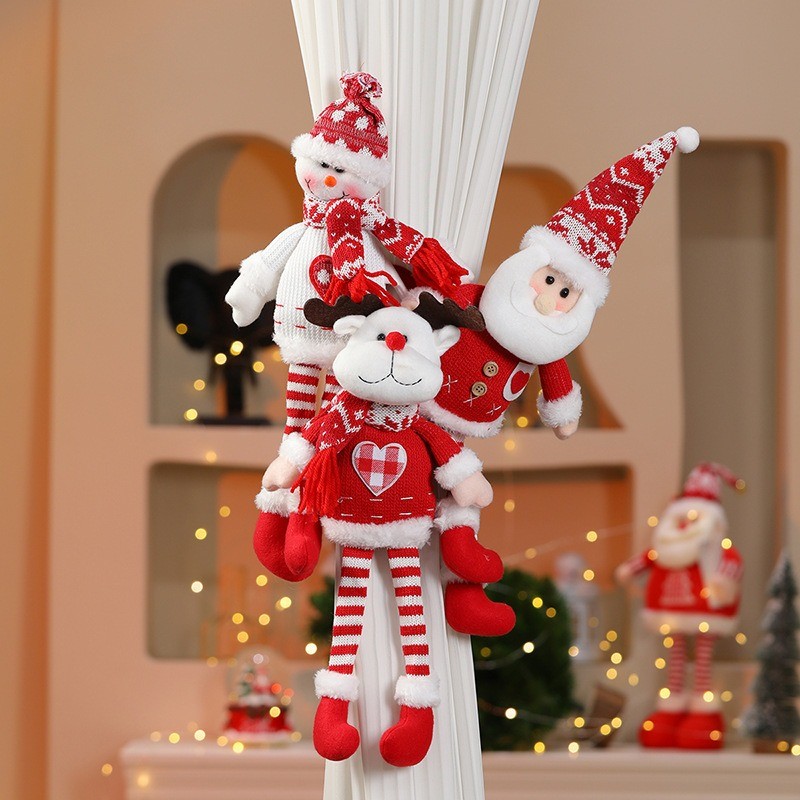 Christmas plush characters wrapped around curtain