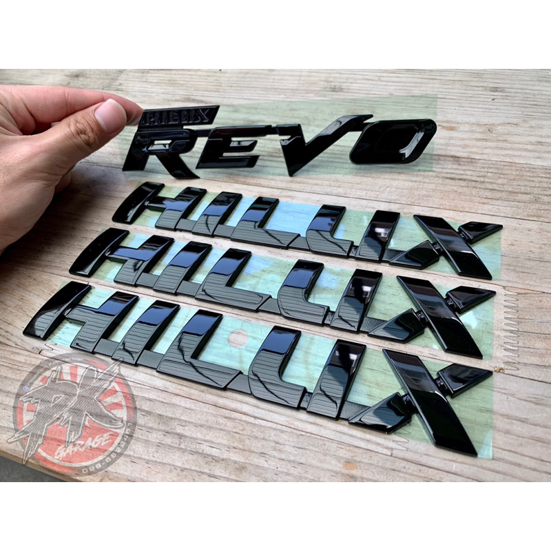 Toyota Hilux Logo Revo Plate Glossy Black Part New Genuine Parts Emblem ...